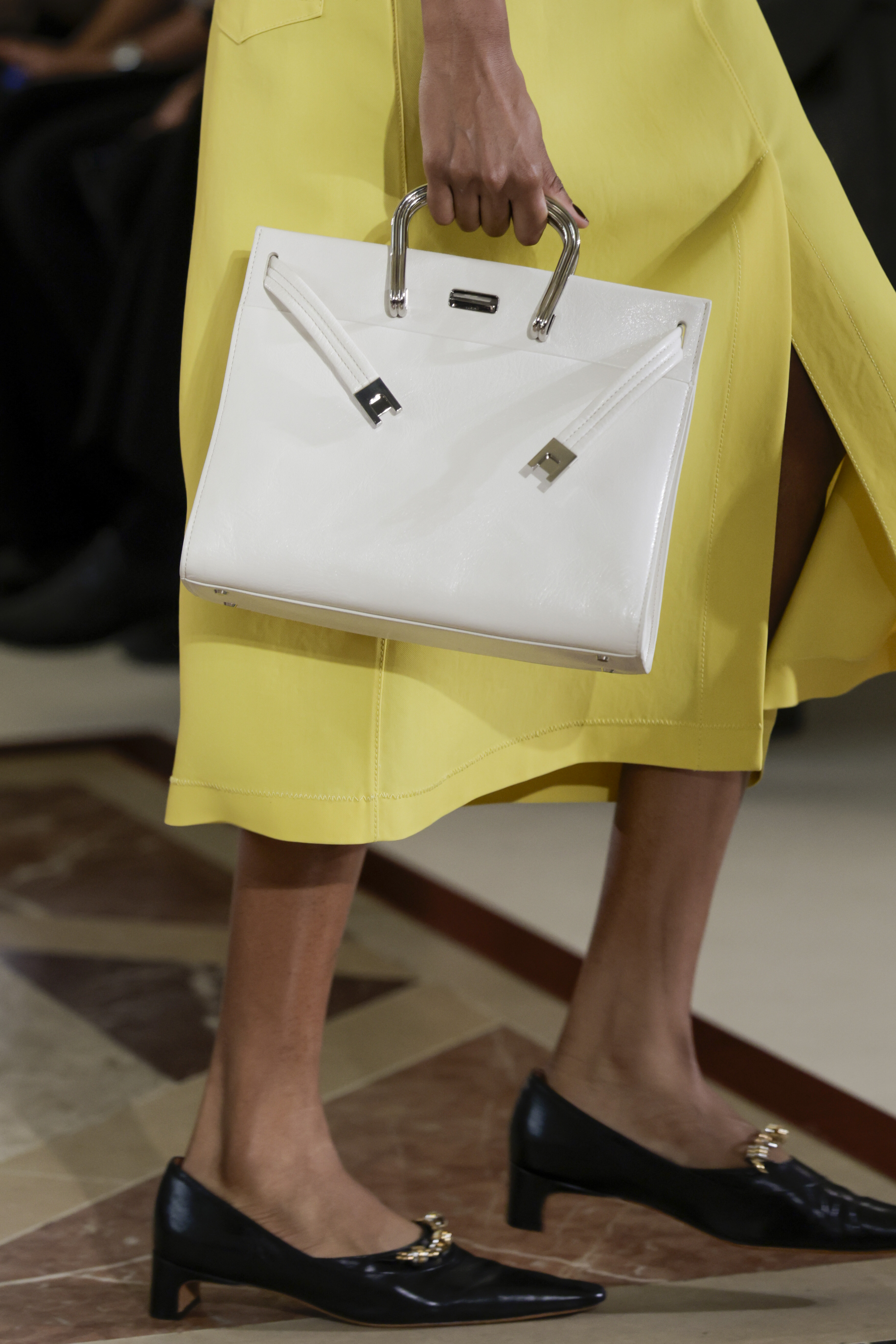 models carry the new Lee Radziwill Tory Burch bags at the spring 2026 fashion show