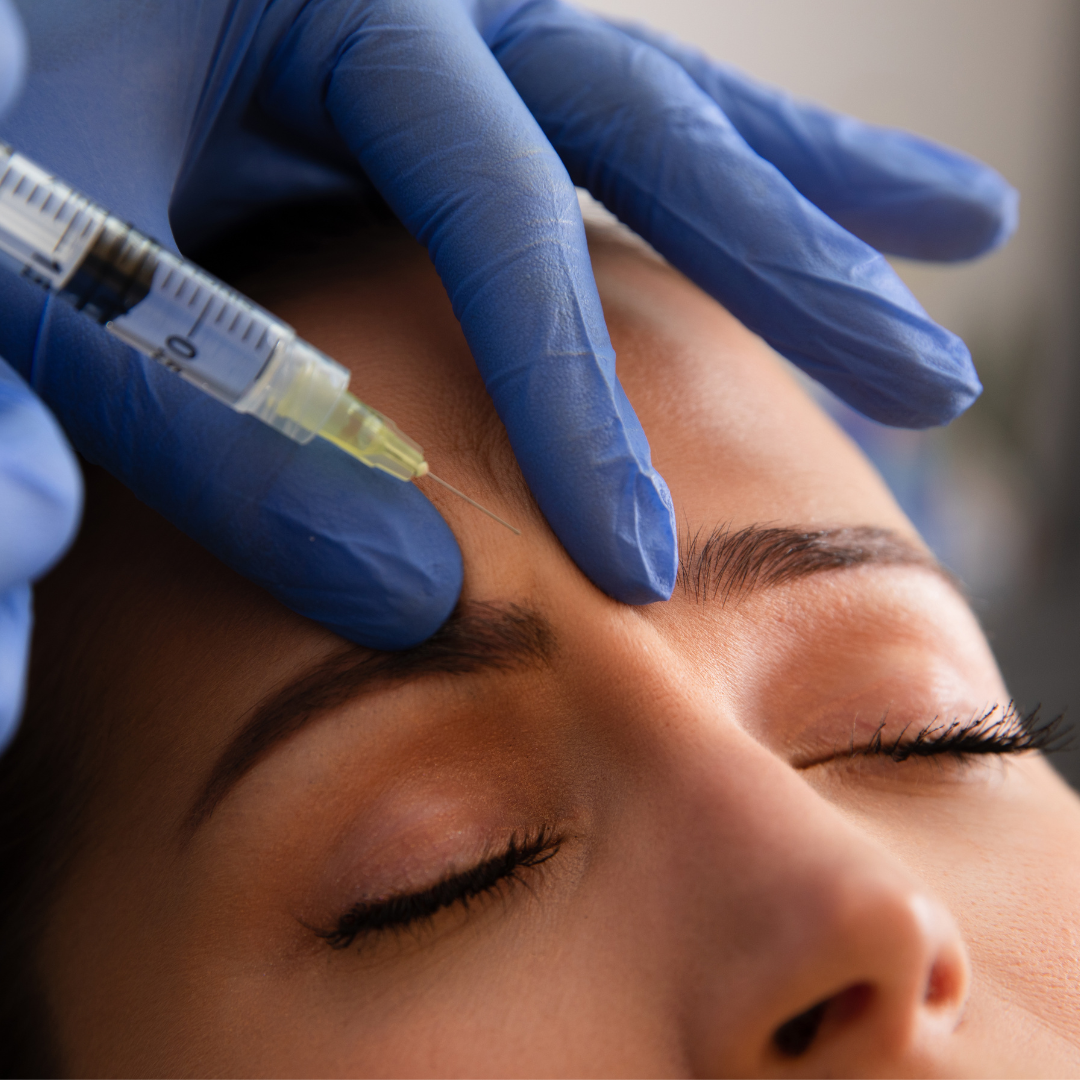 woman getting botox injected into her forehead 