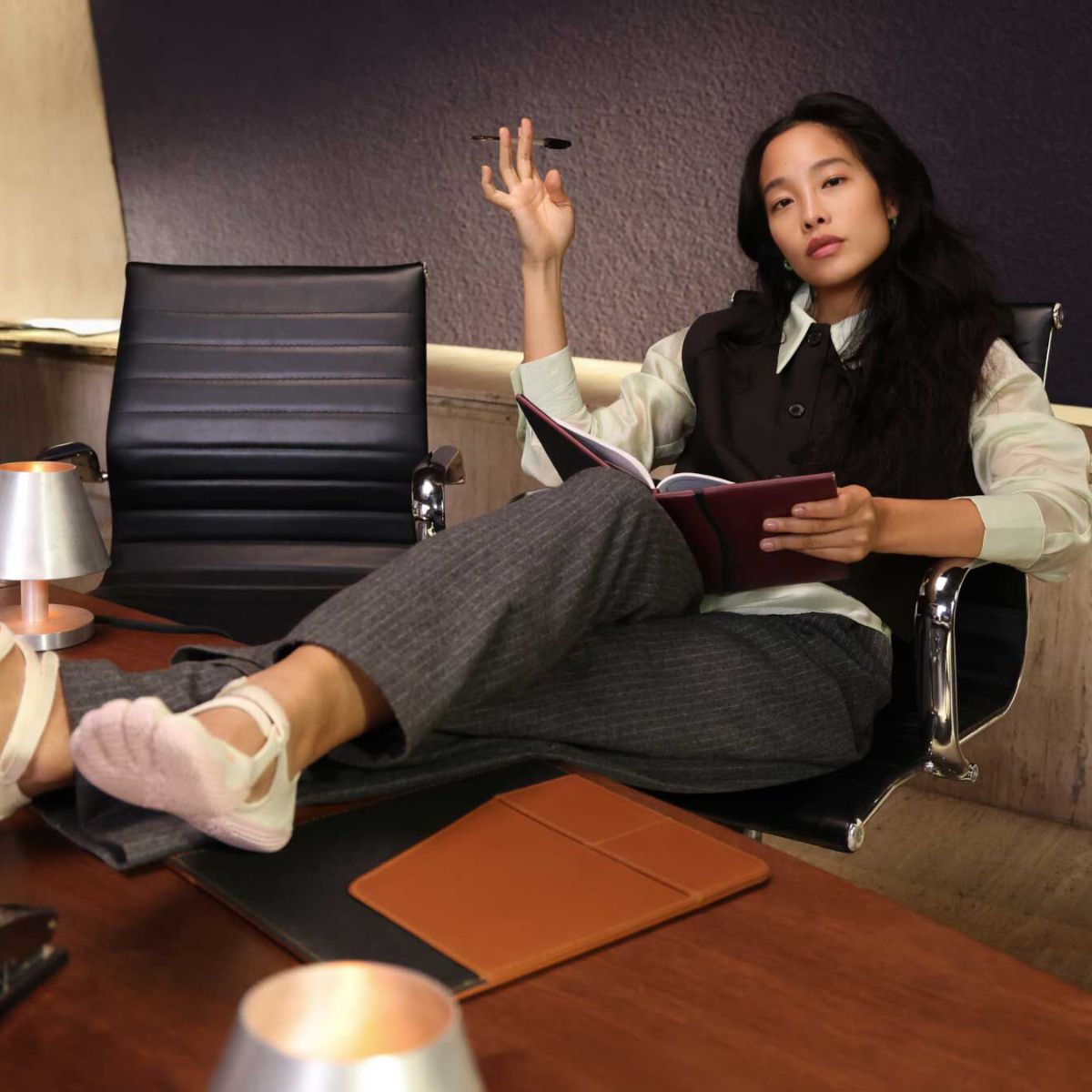 model sat at desk wearing vibram fivefinger shoes