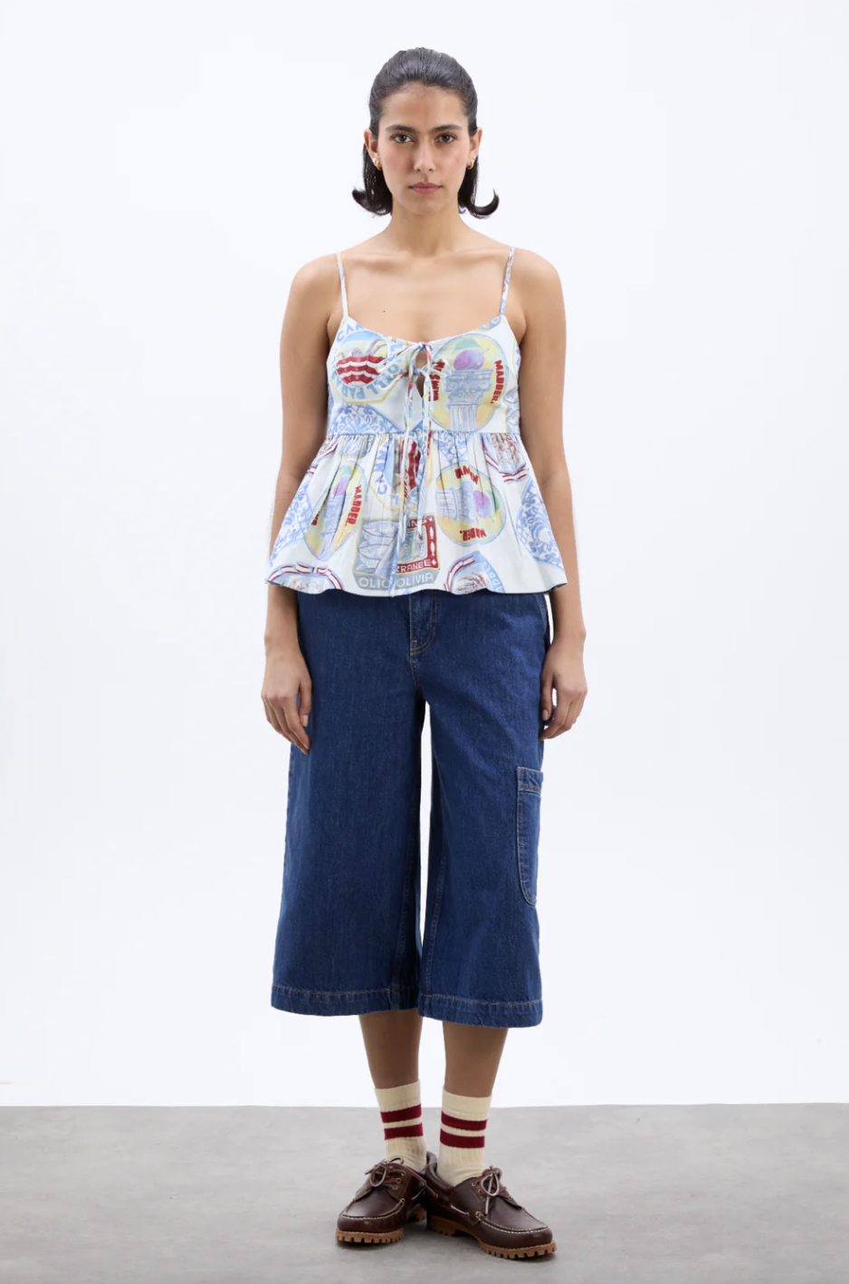 a model wearing a damson madder peplum top and jean culottes