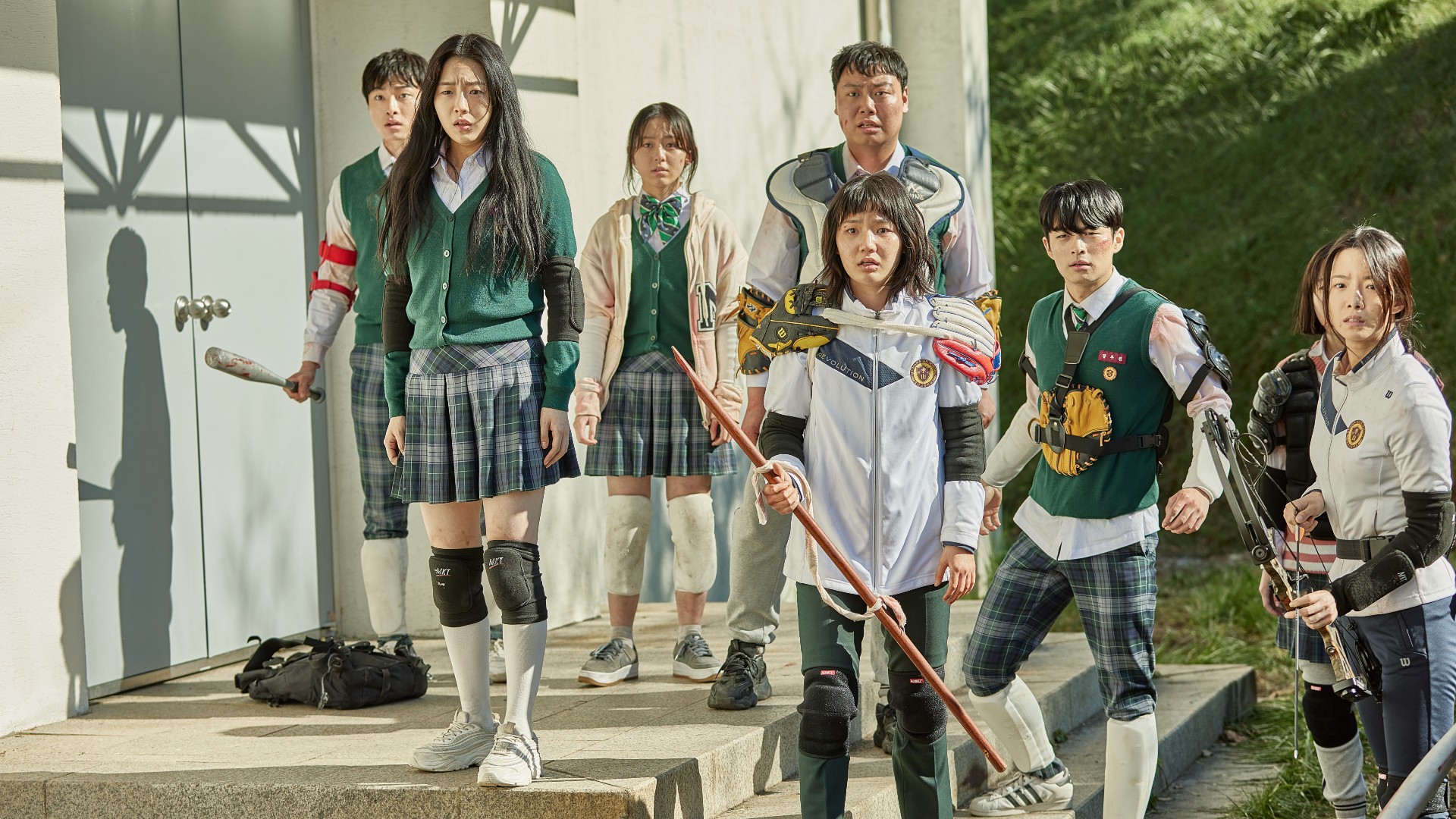 a group of teenagers in school uniforms prepare to battle zombies in a still from all of us are dead