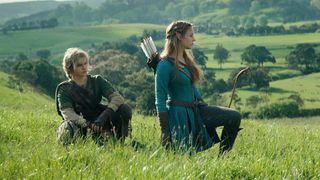 Link squatting in a field with Zelda kneeling next to him in The Legend of Zelda movie