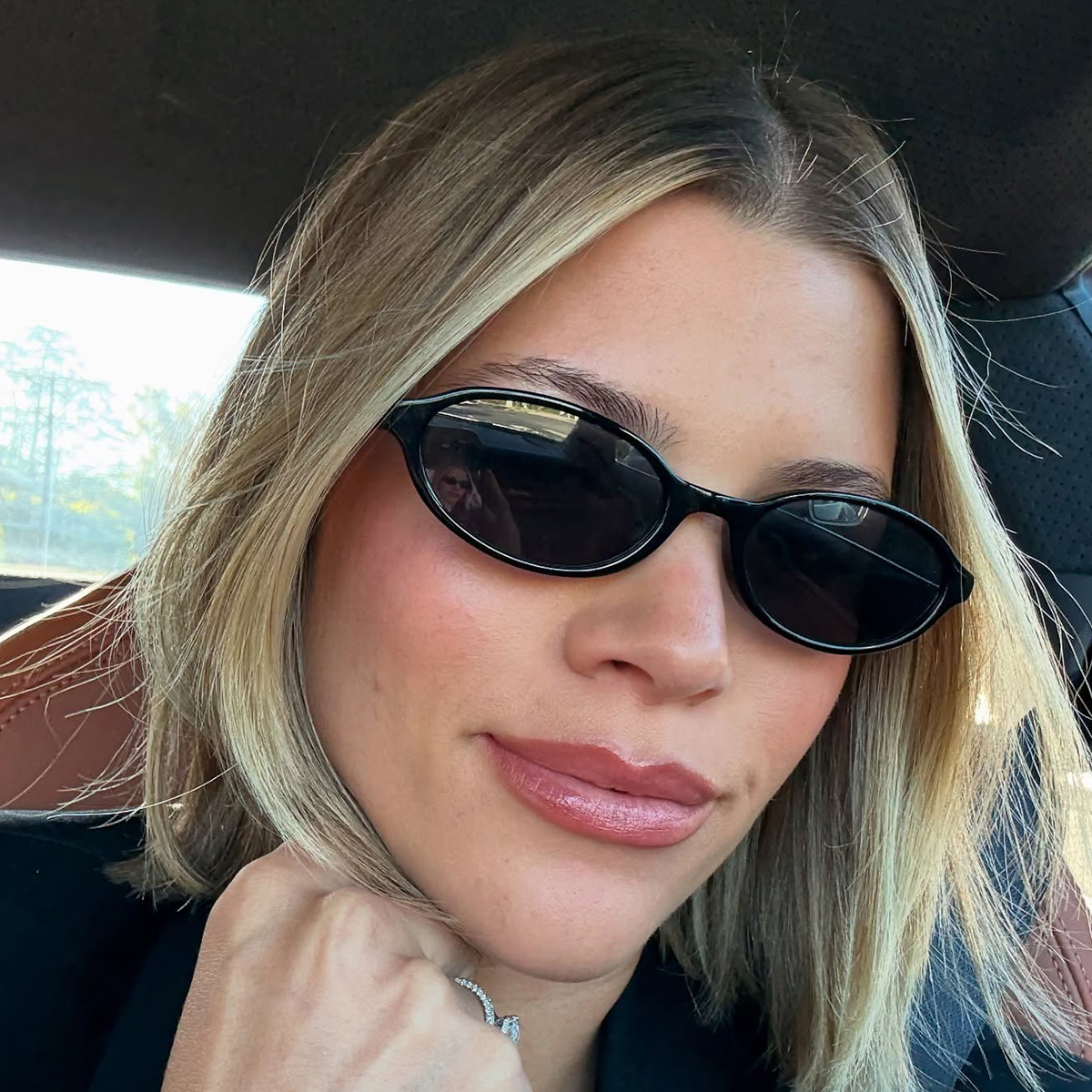 Sofia wearing oval sunglasses.