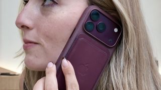 iPhone 18 Pro Max in Burgundy color being held up to ear 
