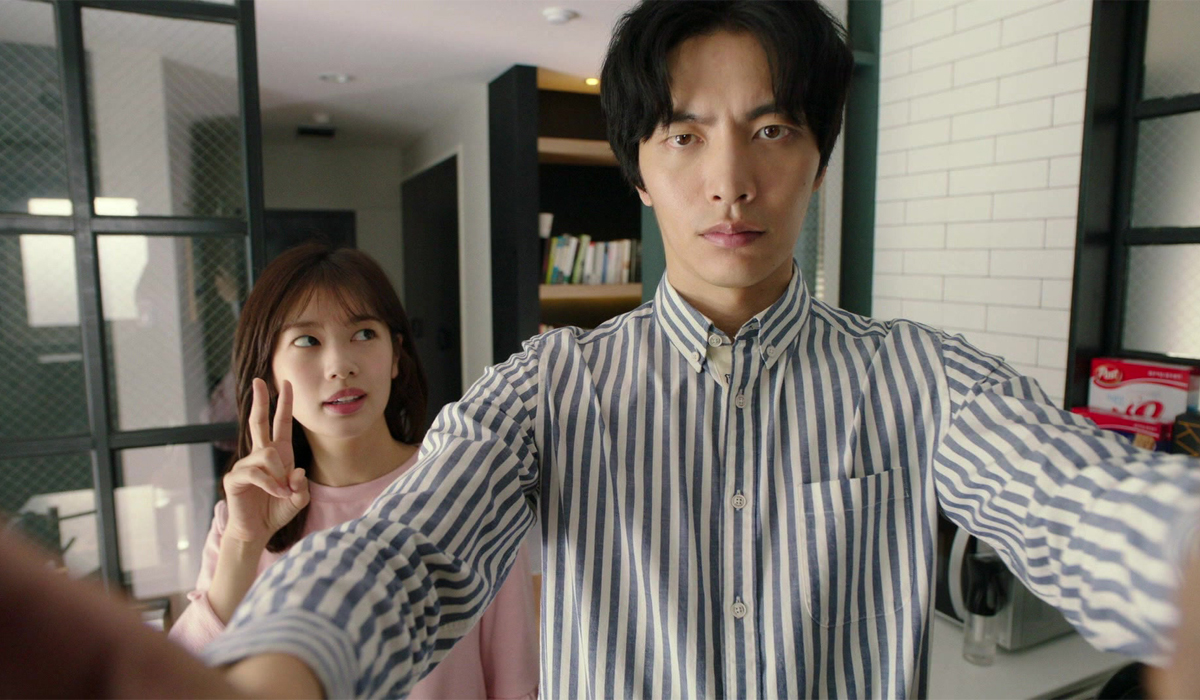 two people (Jung So-min and Lee Min-ki) take a selfie while standing in an apartment, in Netflix k-drama &#039;Because This Is My First Life&#039;