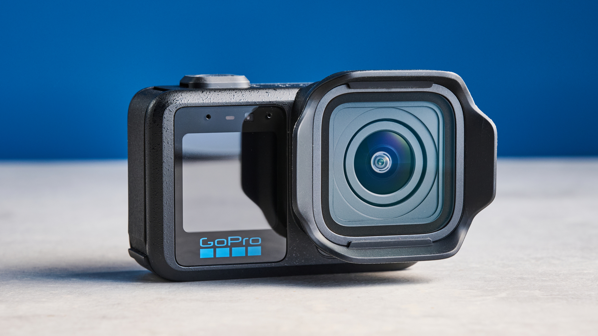 The GoPro Mission 1 Pro on a stone surface against a blue background