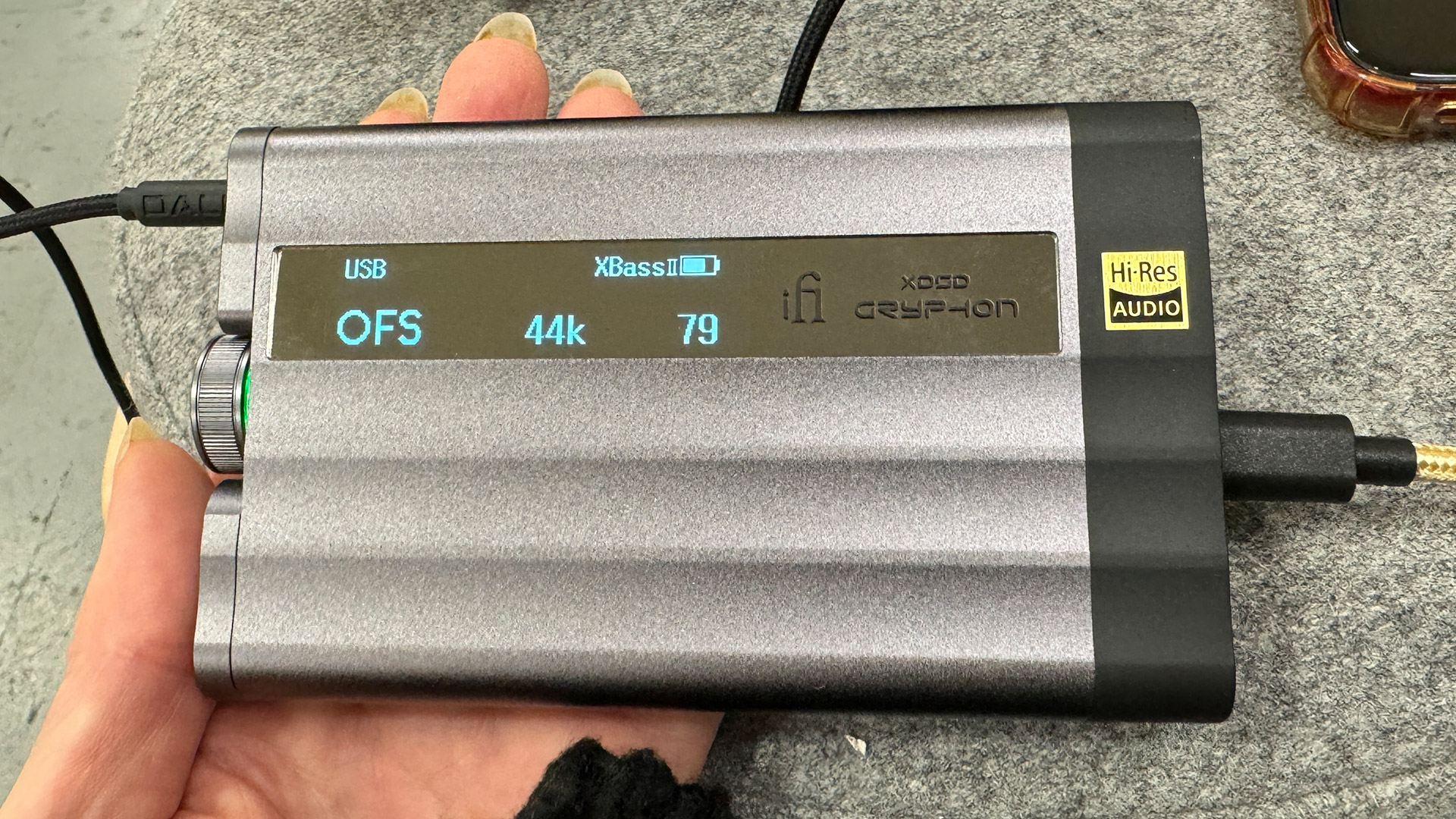 The iFi xDSD Gryphon being held in a hand