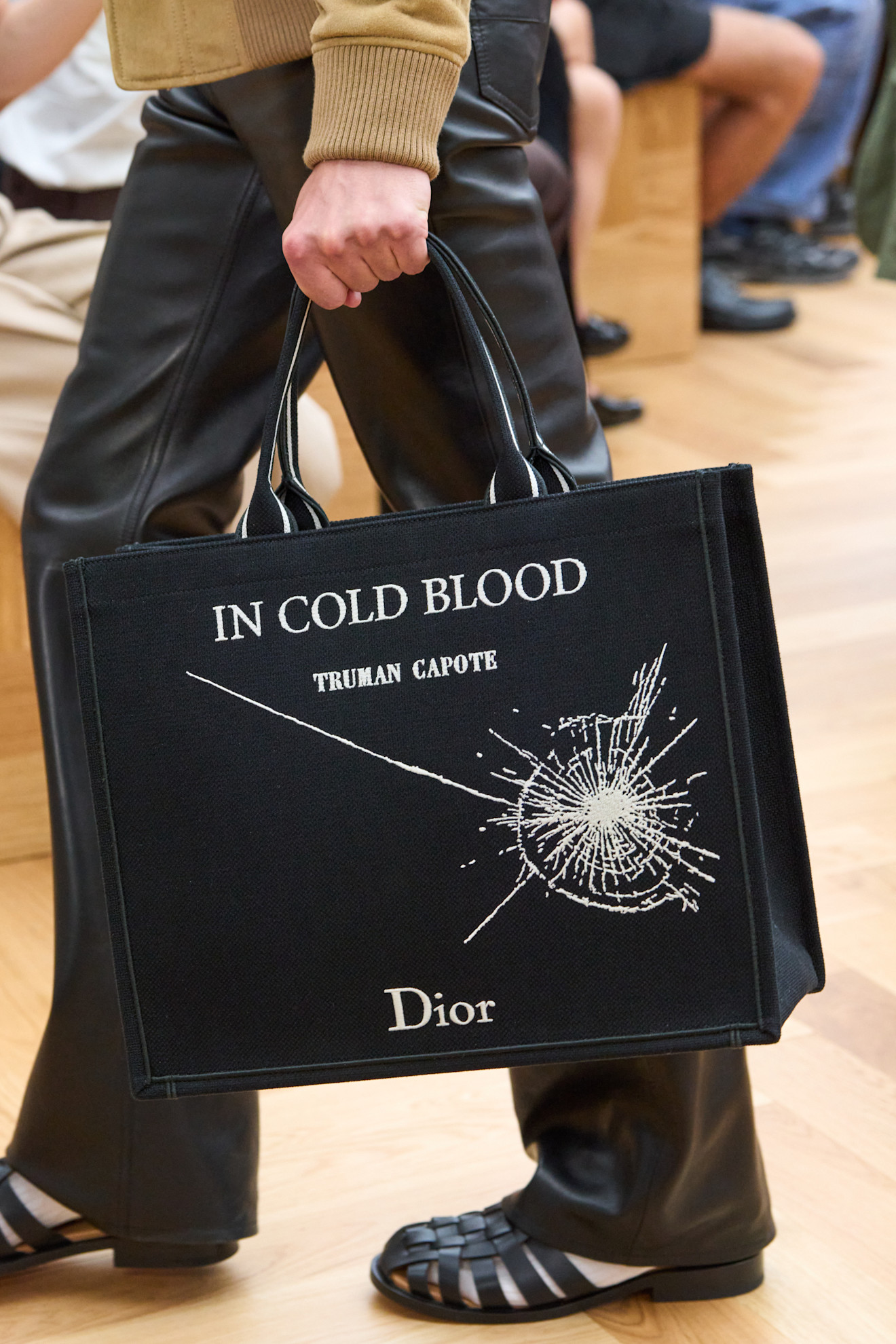 A model carried Jonathan Anderson's new Book Tote on the Dior Men's Spring 2026 runway