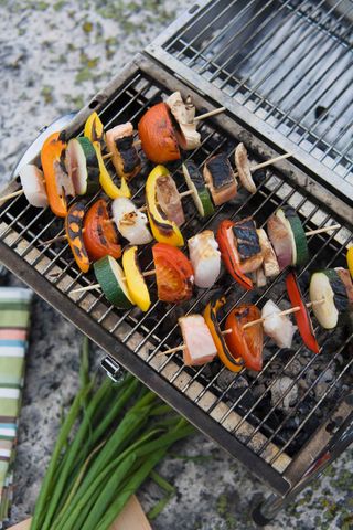 vegetable kebabs cooking on grill