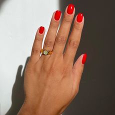 woman wearing Red nail polish 