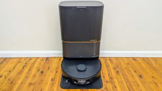 Dreame X40 Ultra showing vacuum and base station against a wall on wooden floors