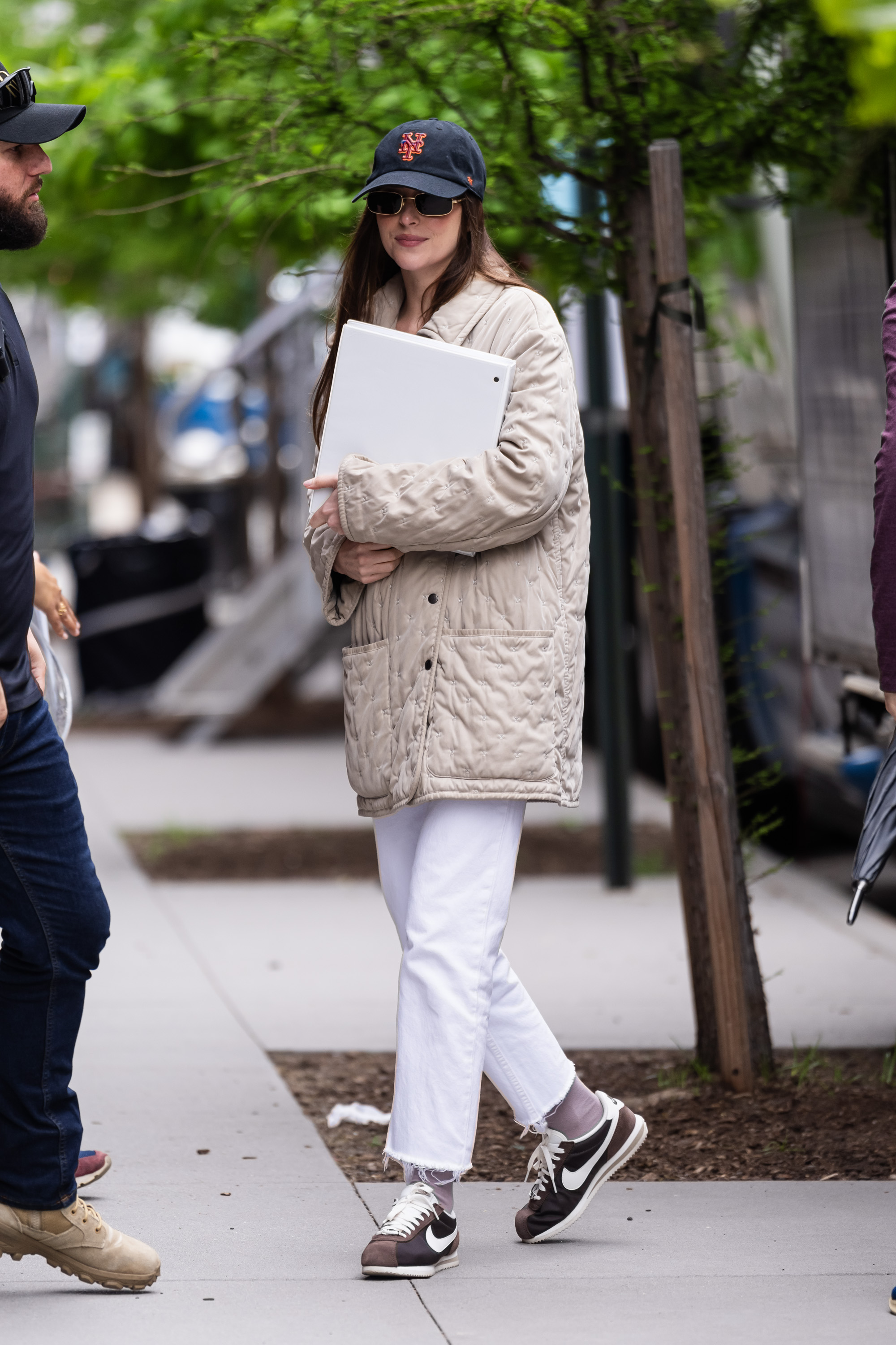 Dakota Johnson wearing brown Nike sneakers in NYC.