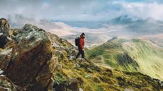 A man hiking in the mountains during the autumn