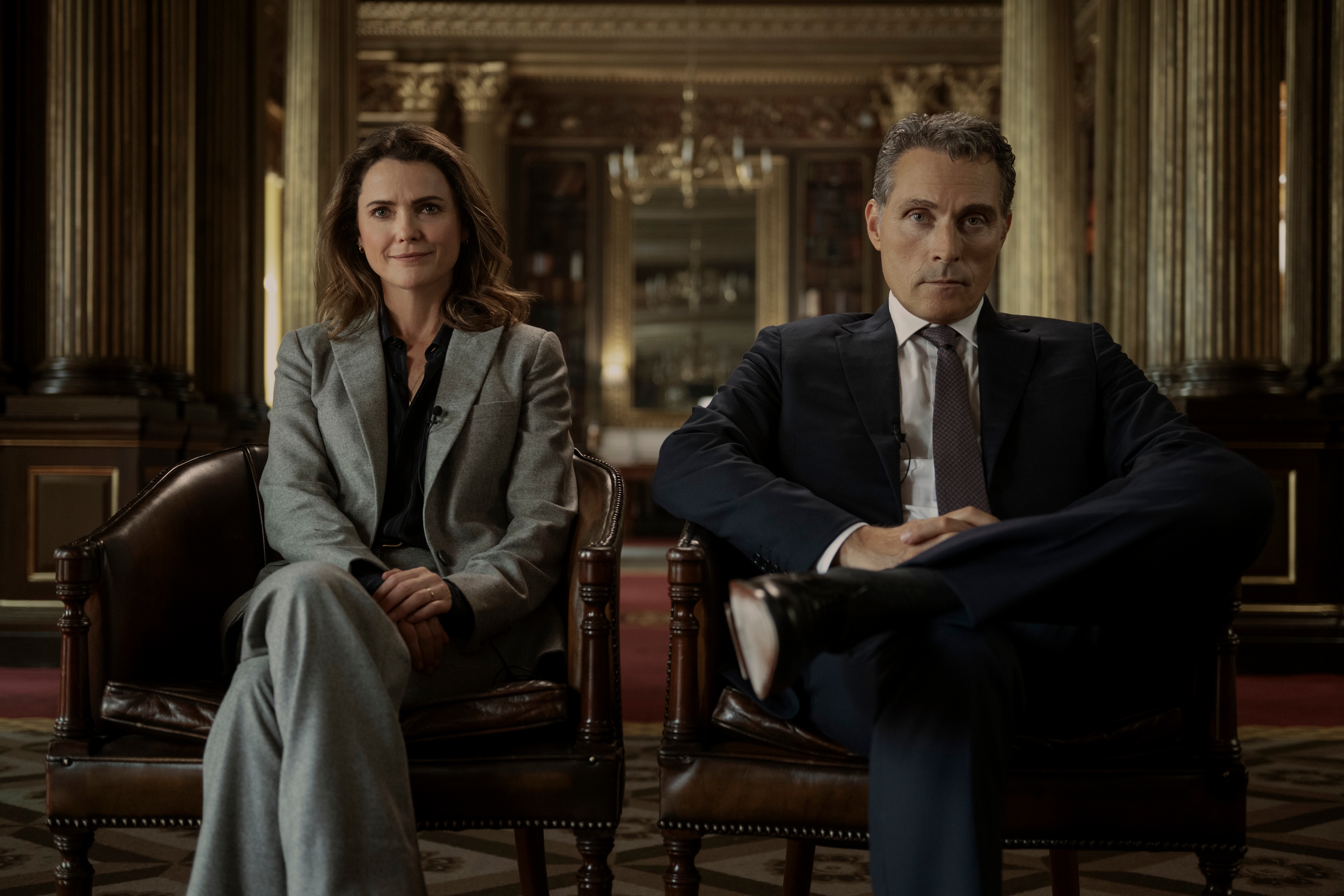 Keri Russell as Kate Wyler and Rufus Sewell as Hal Wyler sitting in two chairs in the prime minister's office in the diplomat season 3