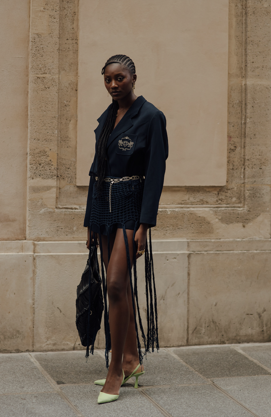 woman wearing blazer and fringed skirt