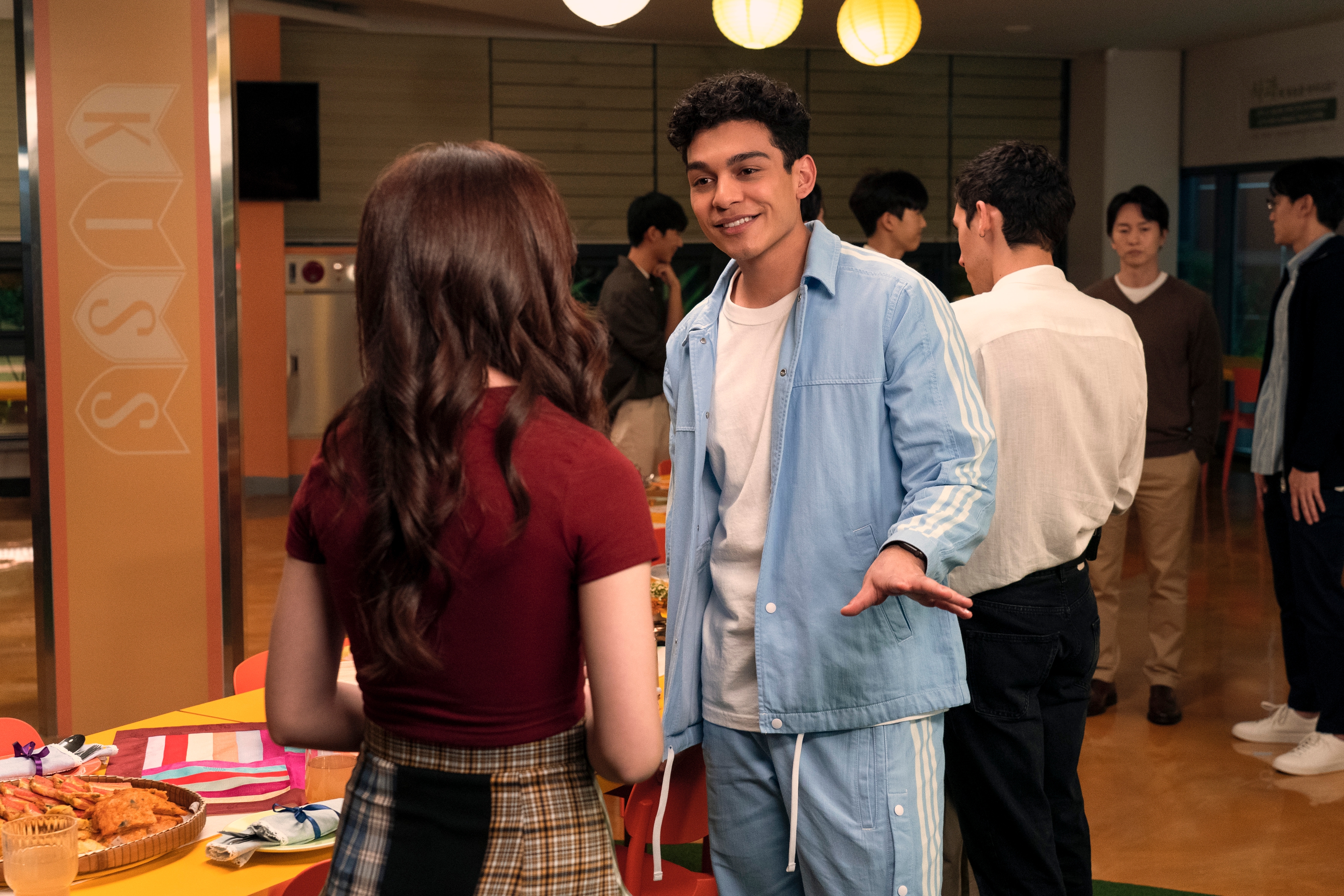 Anthony Keyvan as Quincy &quot;Q&quot; Shabazian in a blue sweatsuit at a school function in xo kitty