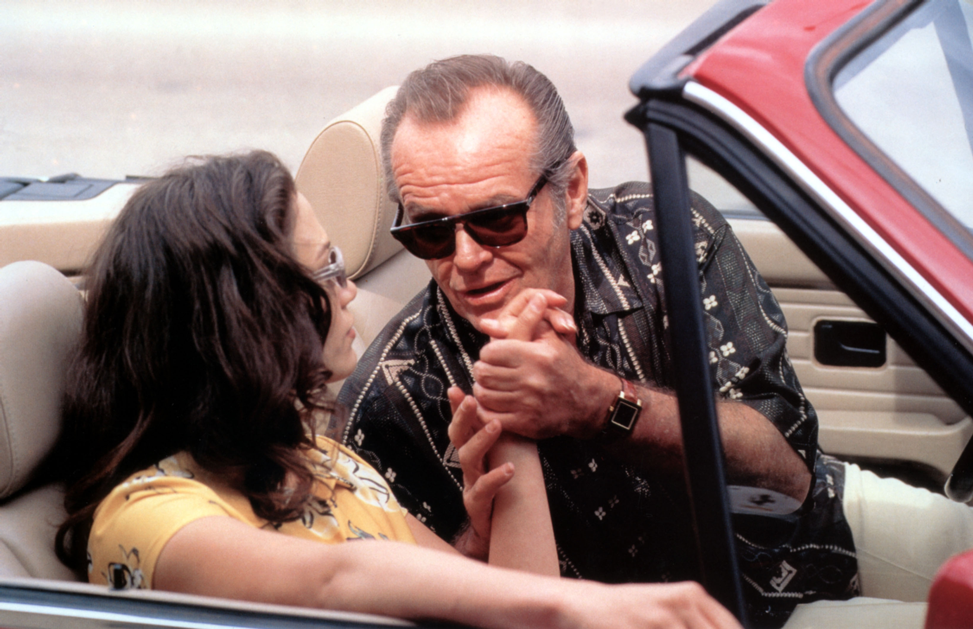 Jack Nicholson grabs jennifer lopez&#039;s hand as they ride in a convertible together in &#039;Blood and Wine&#039;