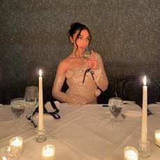 Woman sitting at a table with candles