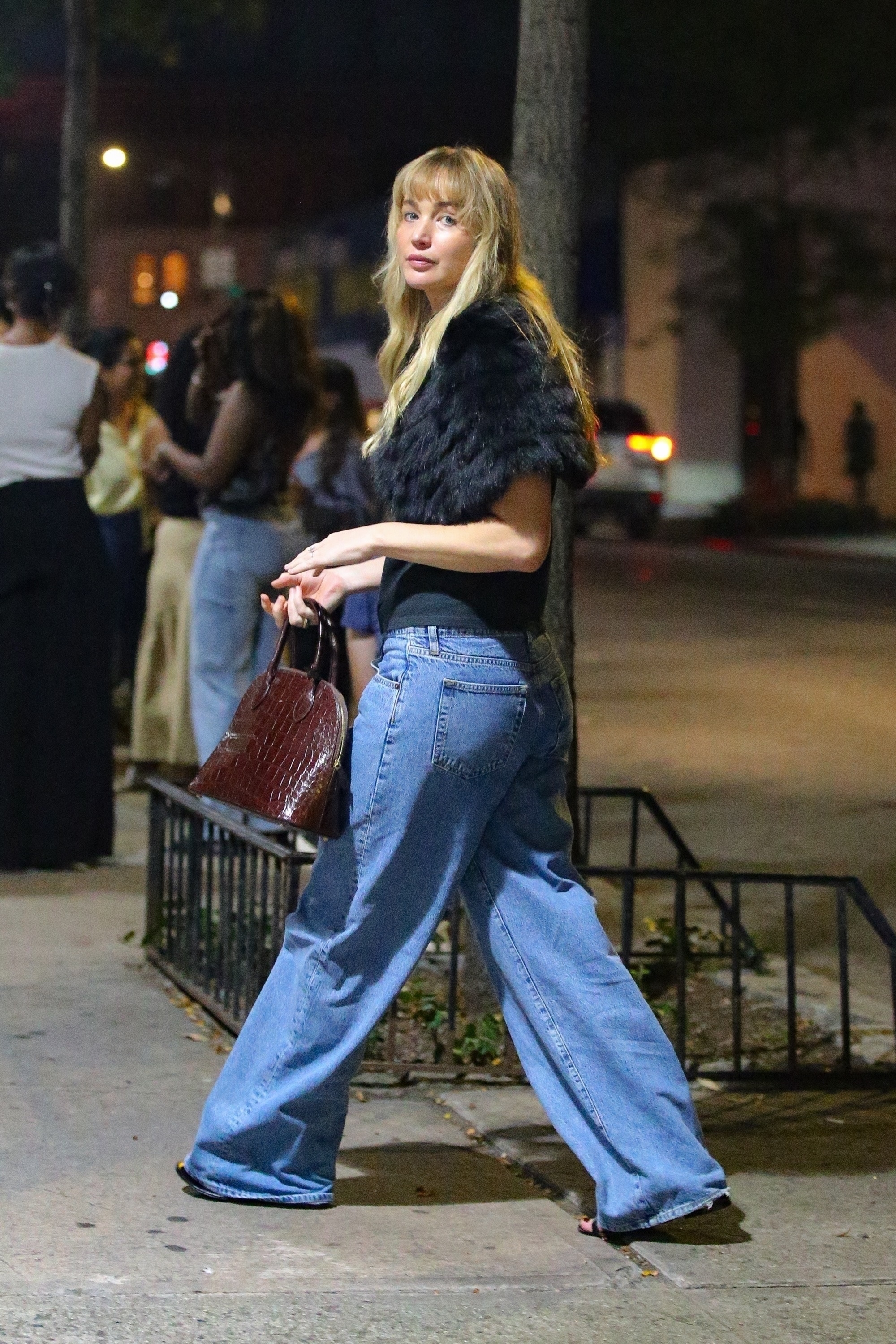 Jennifer Lawrence wore a fur shawl over her shoulders with La Ligne jeans and a five-figure The Row bag