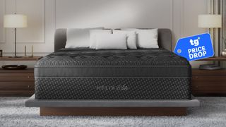 The Helix Midnight Elite Mattress on a bed frame in a bedroom, a Tom's GUide price drop deals badge in the top right corner