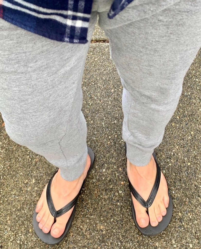 Bro.toes barefoot in flip flops and sweatpants