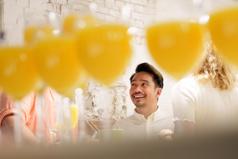 An employee looking up toward a bunch of gold balloons