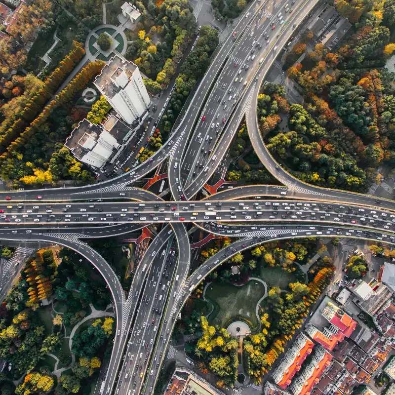 An aerial view of a highway intersection in a city.