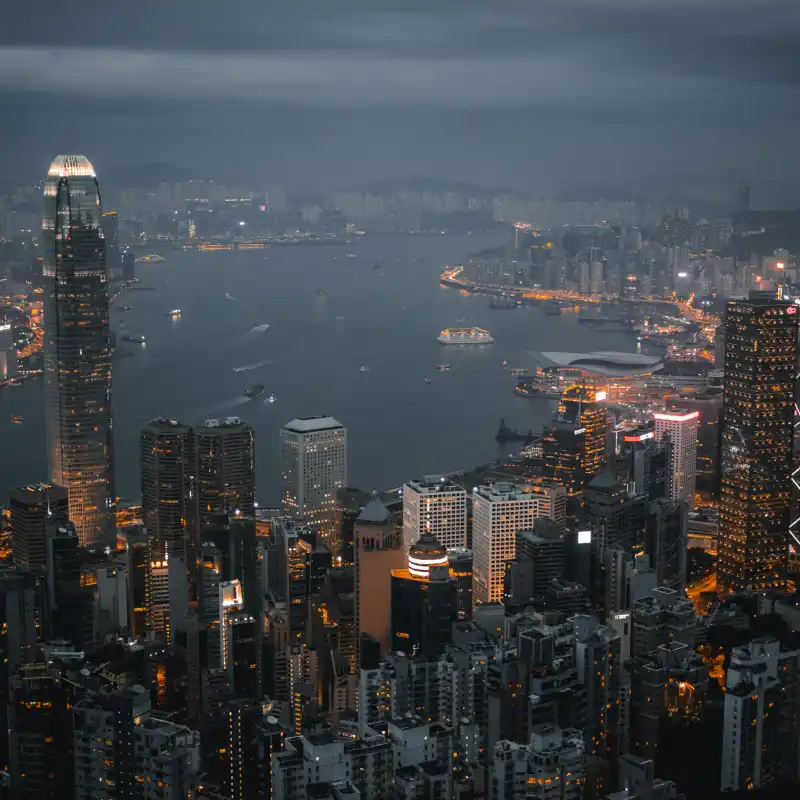 A view of a city at night from the top of a building.