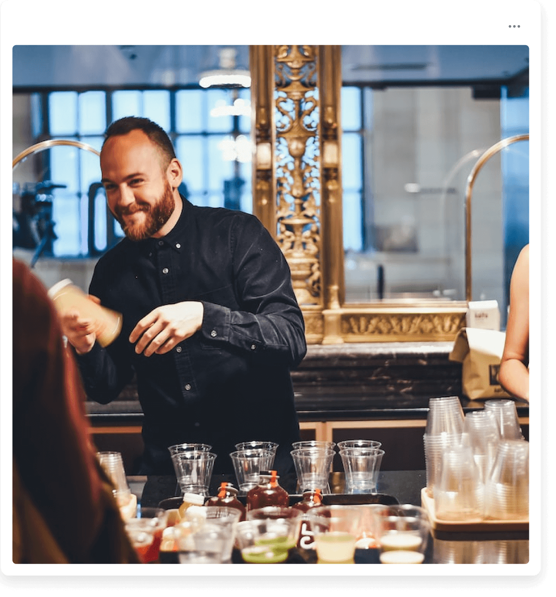 A man standing in front of a counter filled with glasses