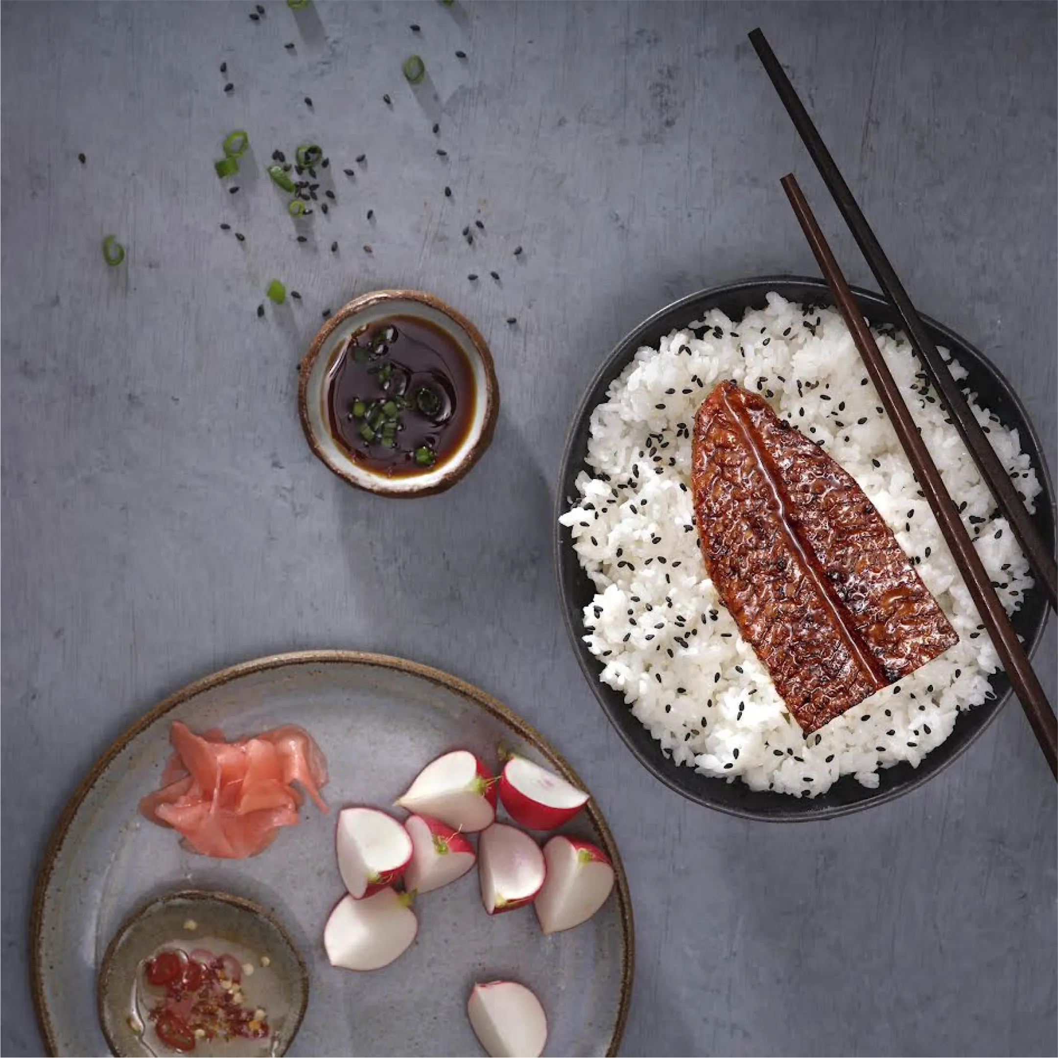 A plate of food with chopsticks and chopsticks next to it.