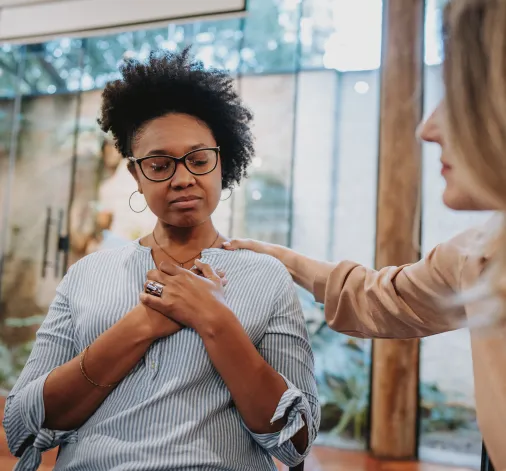 a woman helping another woman grief