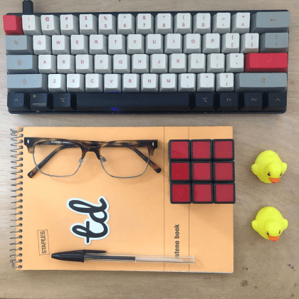 A keyboard, glasses, test double logo and rubber duckies.