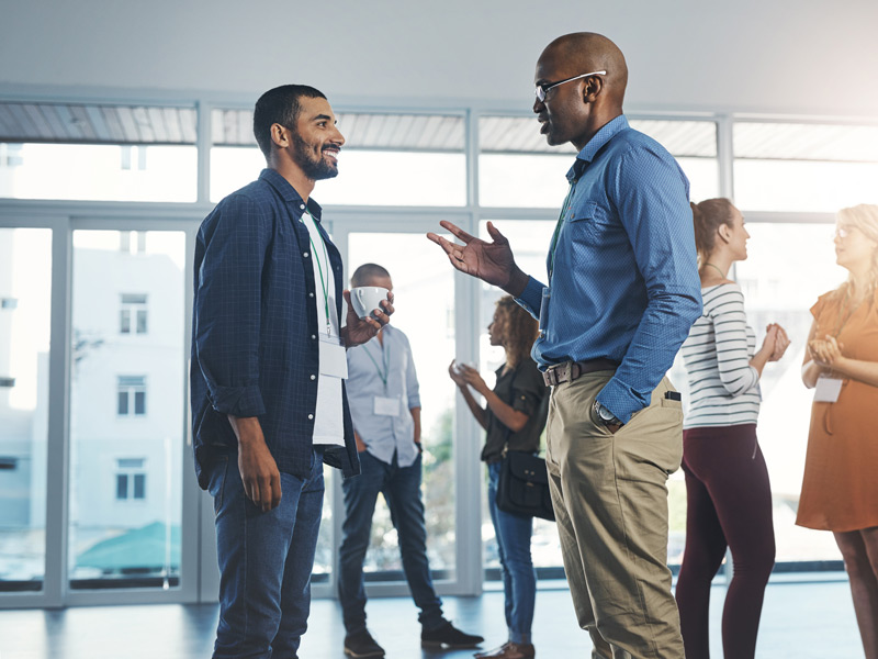 Two men standing and having a conversation.