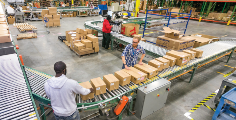 Multiple employees diligently moving boxes at the MacPherson's warehouse