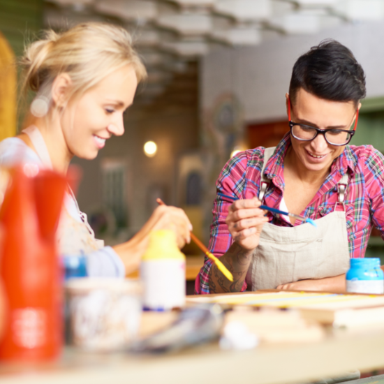 Two friends enjoying painting together