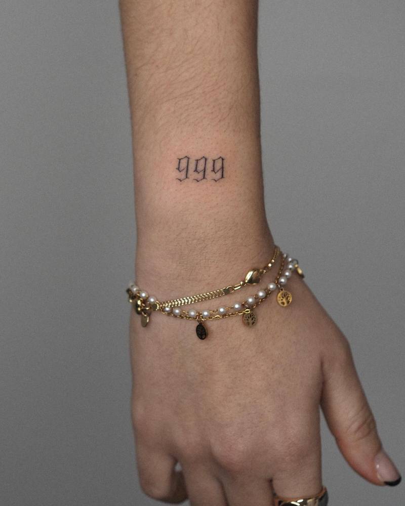 Tattoo of the number "999" located on the wrist.