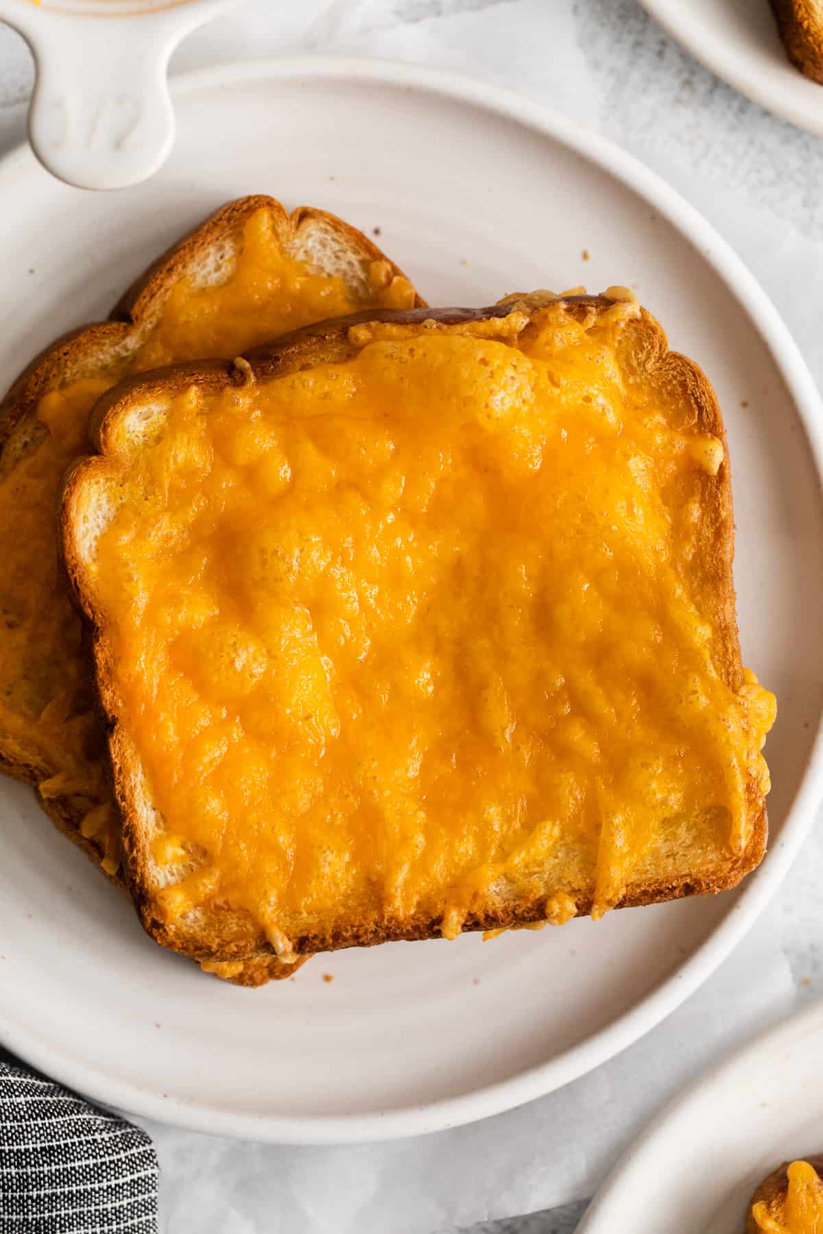 Cheese toast on a plate.