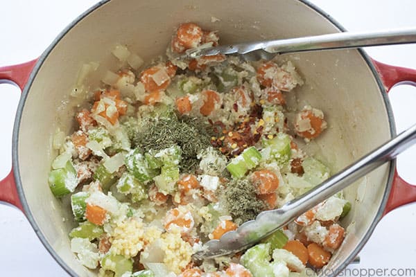 Spices added to veggies in pot