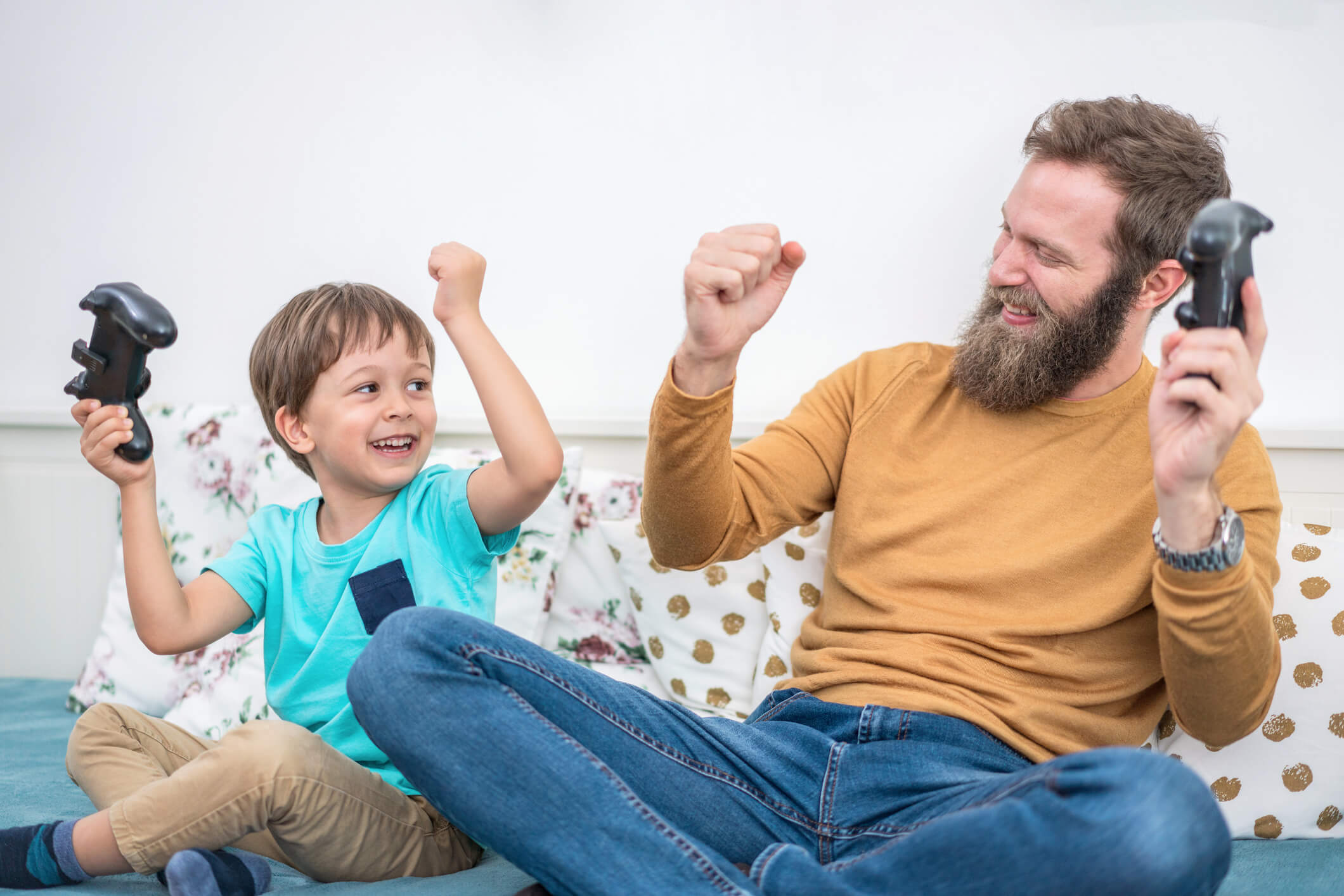 Happy kid and his dad playing a game