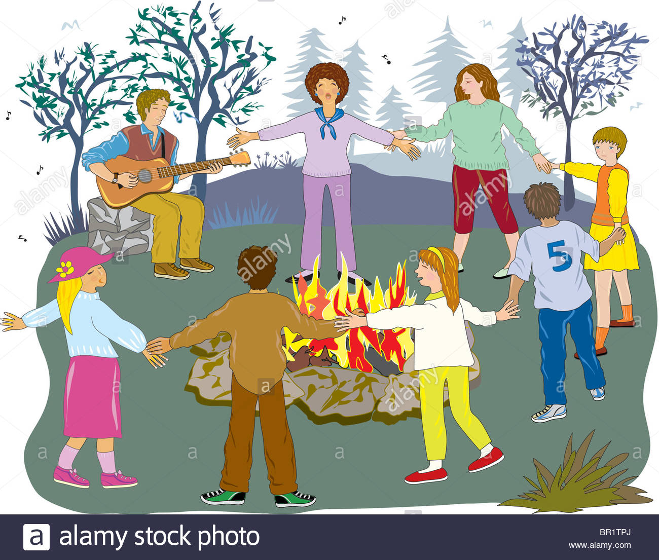 A group of friends holding hands around a campfire Stock Photo.