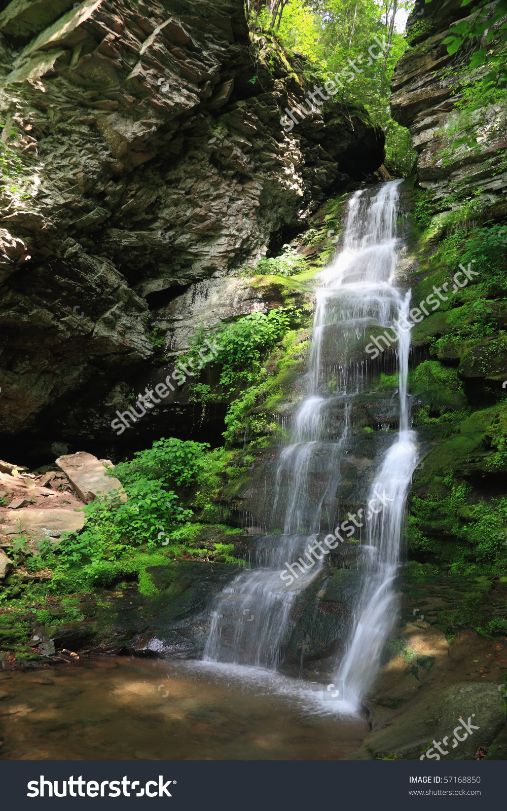 Buttermilk Falls Drips From A Cleft In The Rocks Into A Shallow.