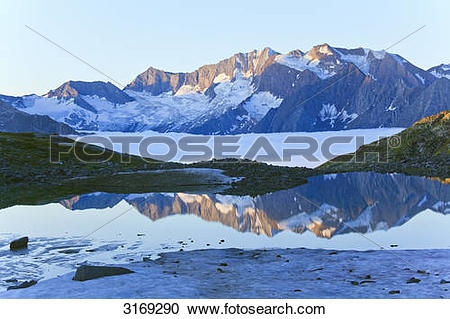 Stock Photography of Mountain lake reflecting Zillertal Alps.