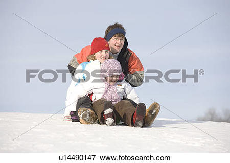 Picture of 15, 13 and 9 year olds prepare to slide down hill.