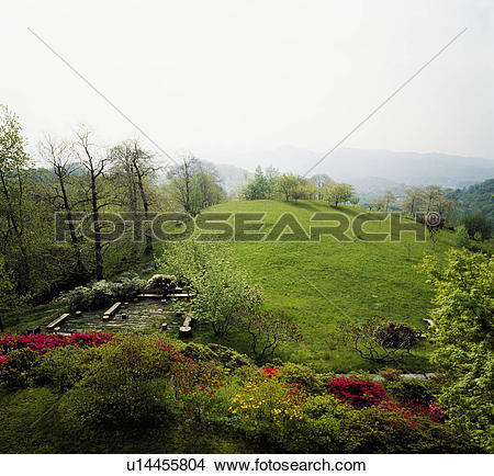 Stock Photo of View from large garden over grassy hilltop in.