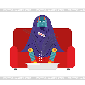 Robot sick sitting in armchair wrapped in blanket..