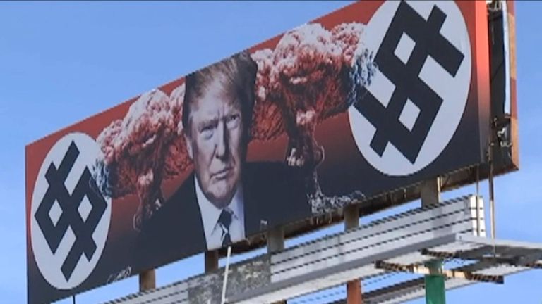 Row over Trump billboard with \'swastika dollar signs.