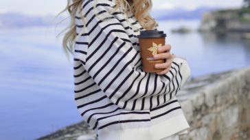 woman in white near calm body of water