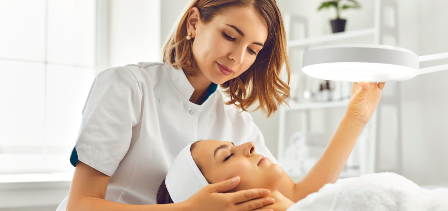 A woman is getting a facial treatment in a beauty salon.