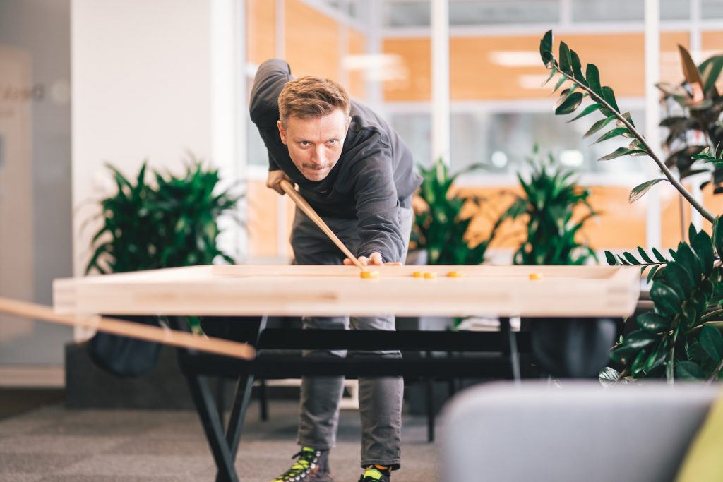 Office worker playing novuss at work in the office game room