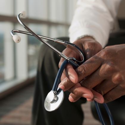 Doctor holding stethoscope in both hands